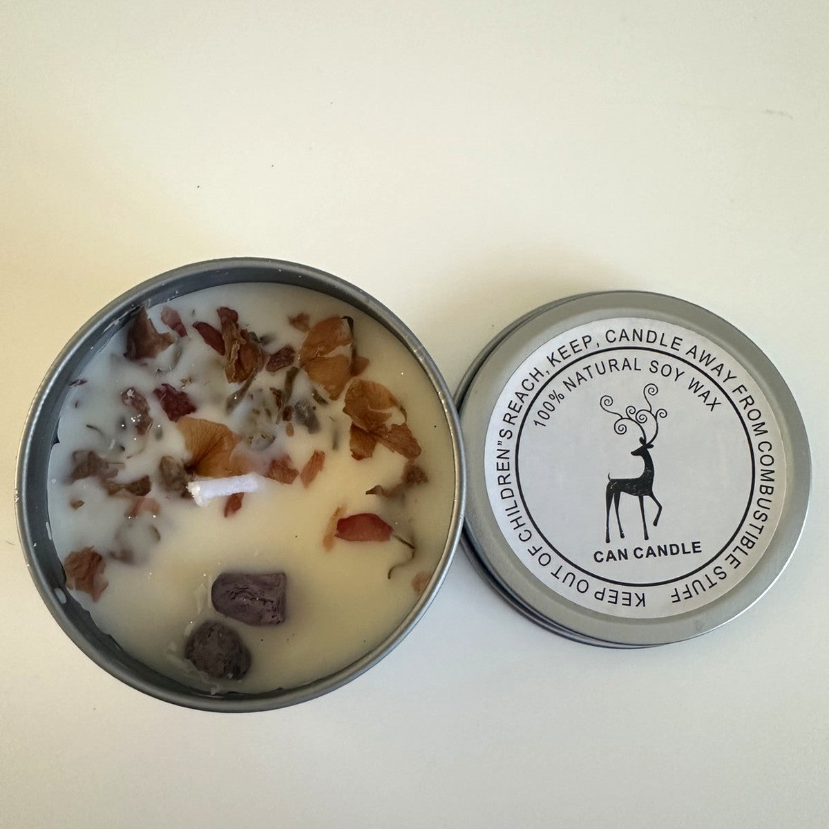 Soy candle top view with petals and crystals